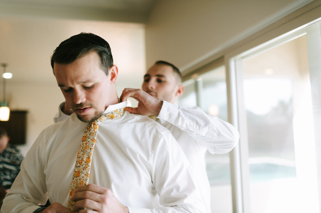 Kaleb gets help with his tie from his brother-in-law