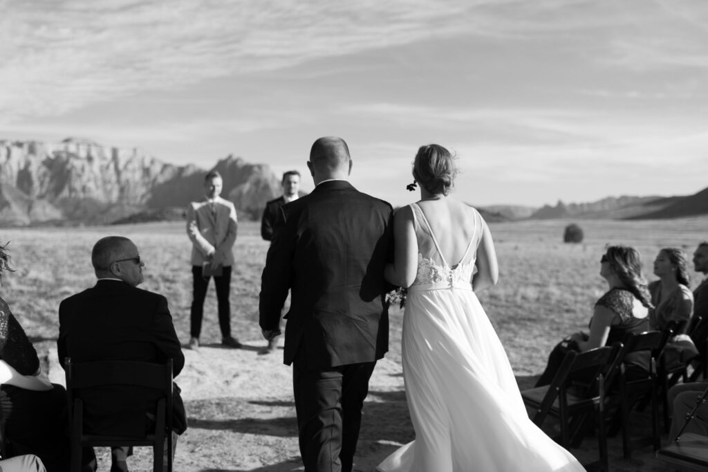 Nicole walks down the aisle with her father for her Zion National Park elopement