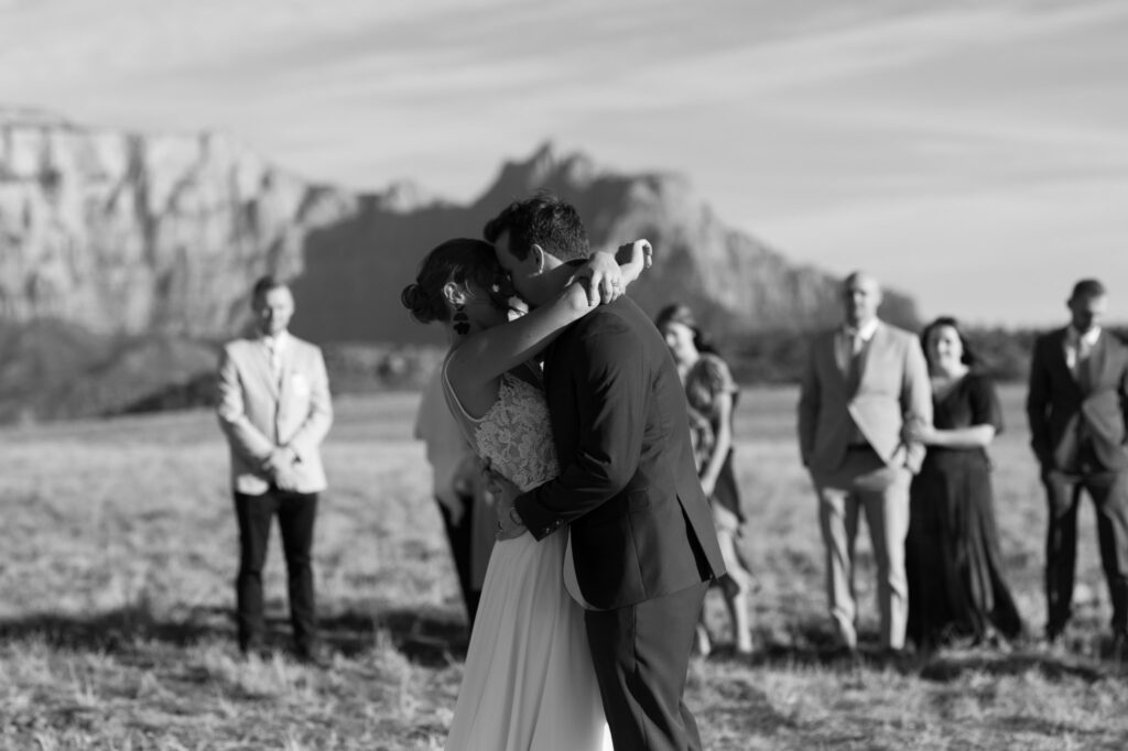Kaleb and Nicole have their first dance in front of their families with Zion National Park in the back