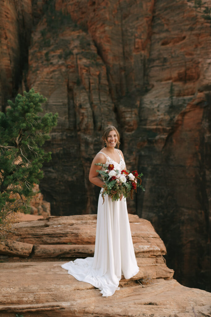 The bride looks at the camera for her bridal portraits at Zion National Park