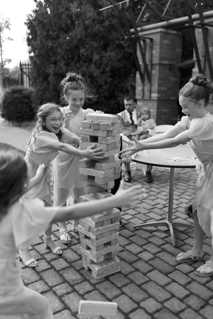Kids play jenga at the cocktail hour