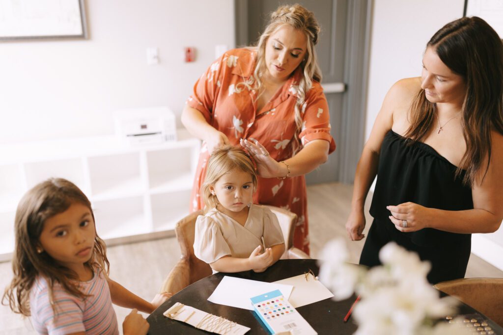 The flowergirls decorate cards while getting their hair done