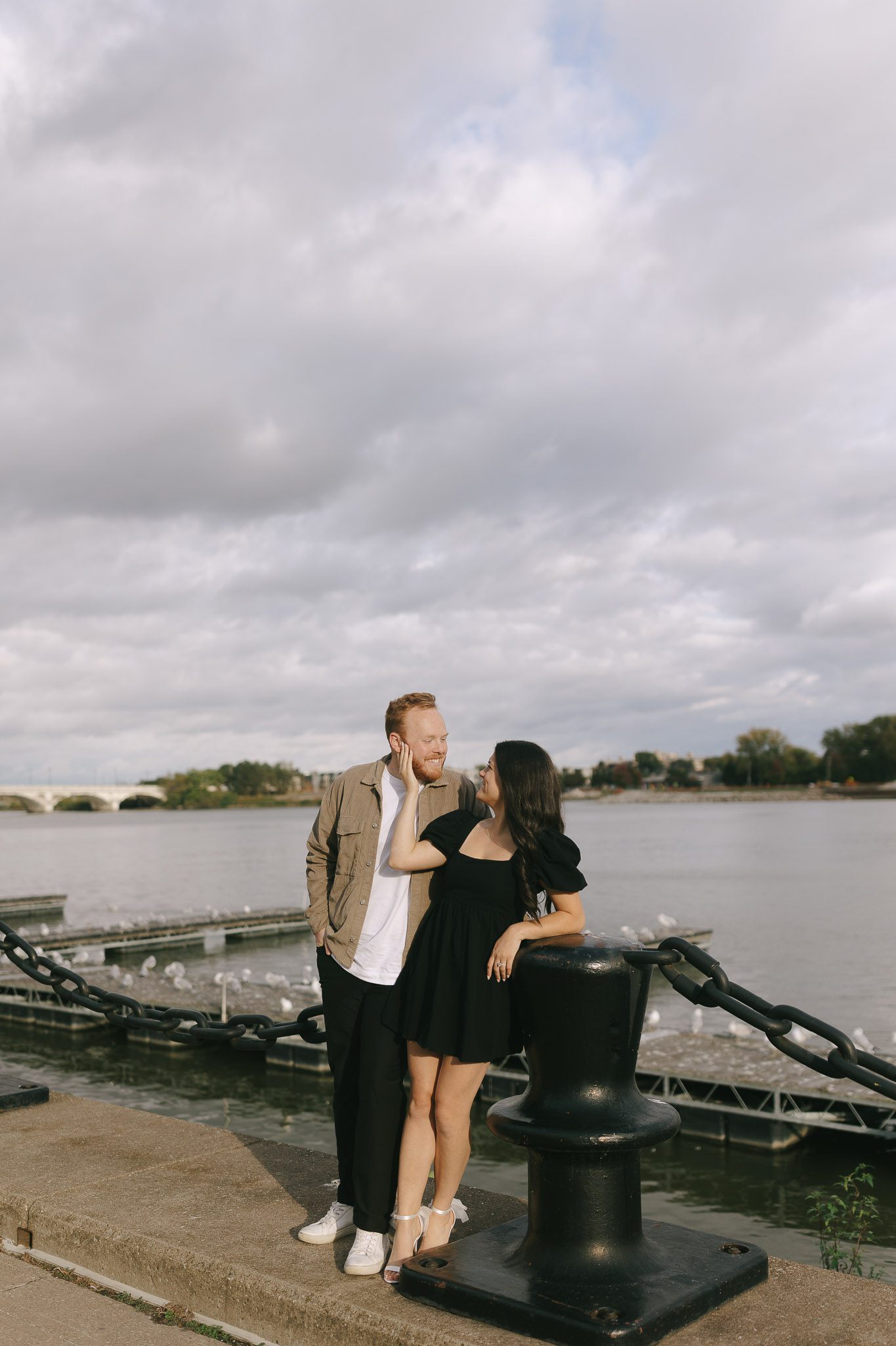Couple stands in Promenade park for their Downtown Toledo engagement photos