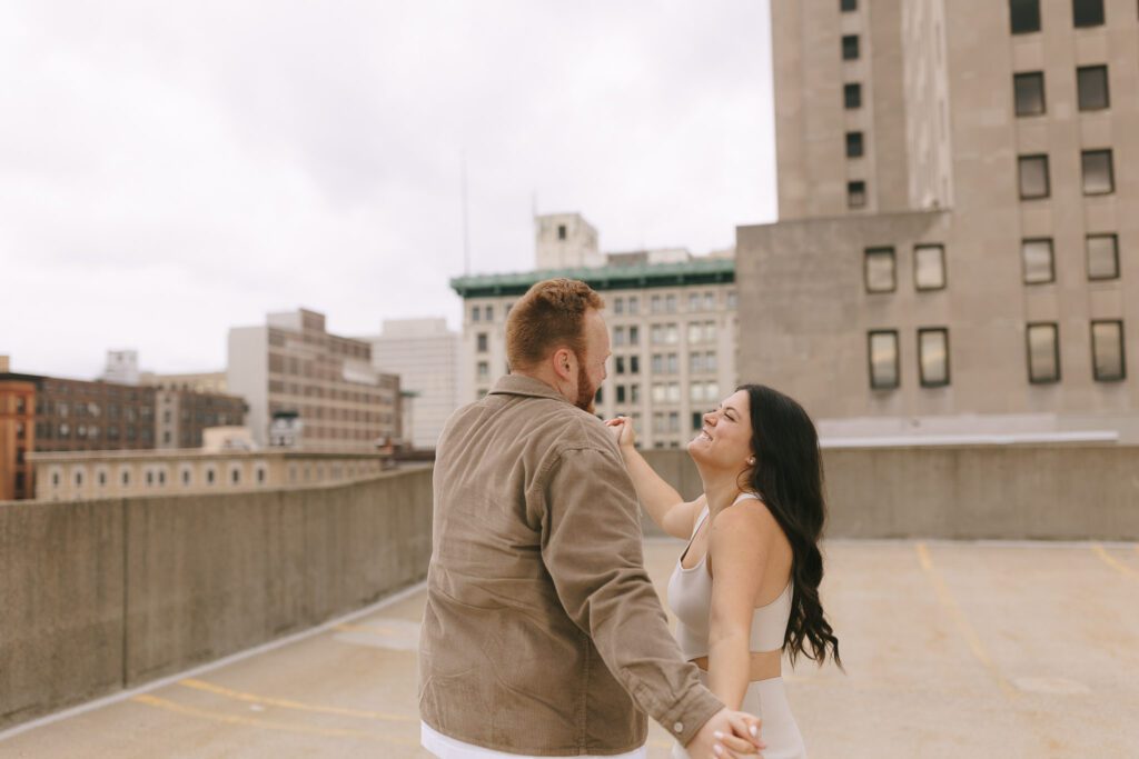 Couple spins on rooftop for their Downtown Toledo engagement photos