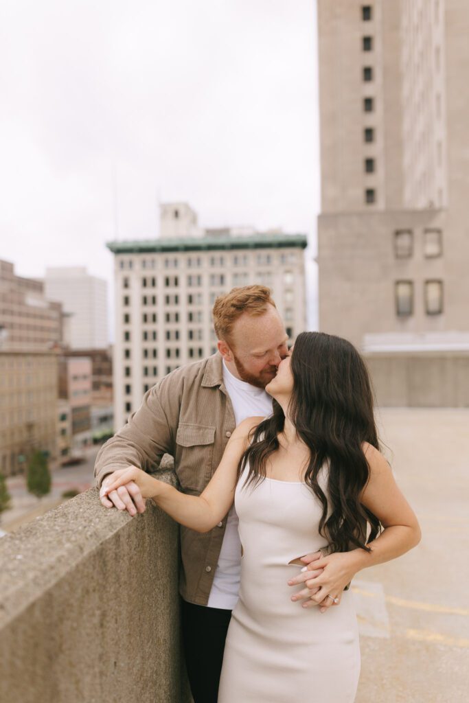 Couple embraces on rooftop for their Downtown Toledo engagement photos