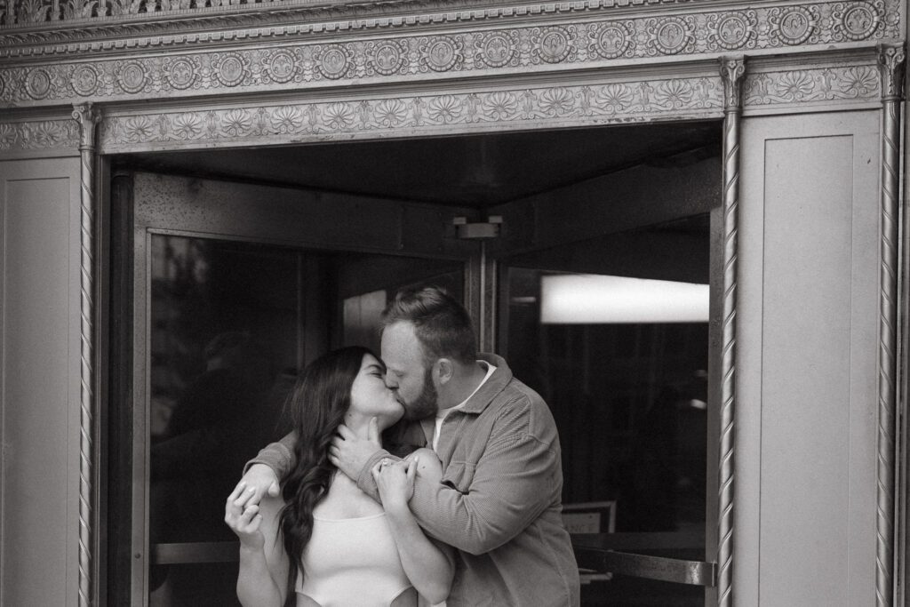 Couple stands in front of building for their Downtown Toledo engagement photos
