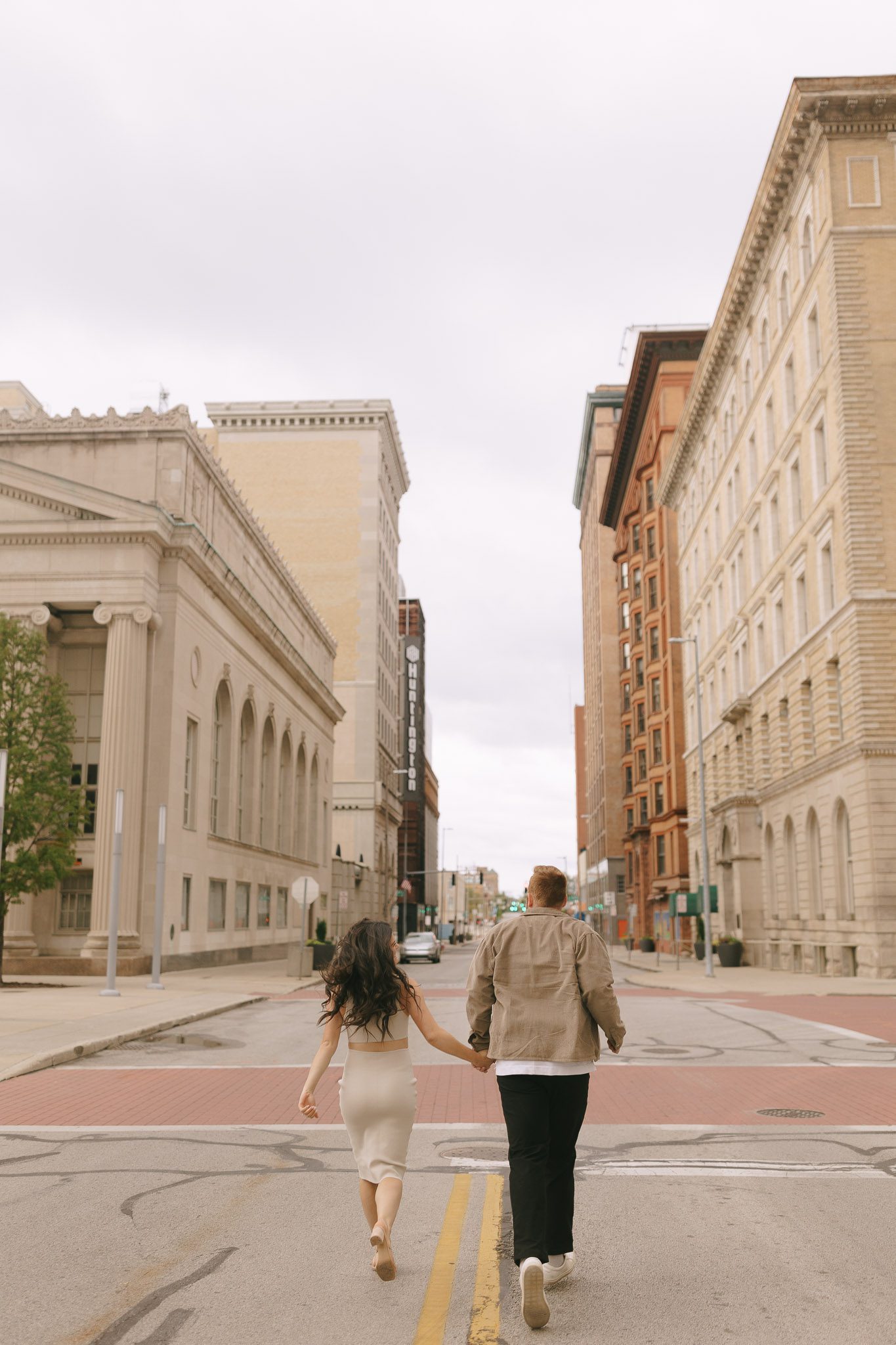 Couple runs down the street for their Downtown Toledo engagement photos