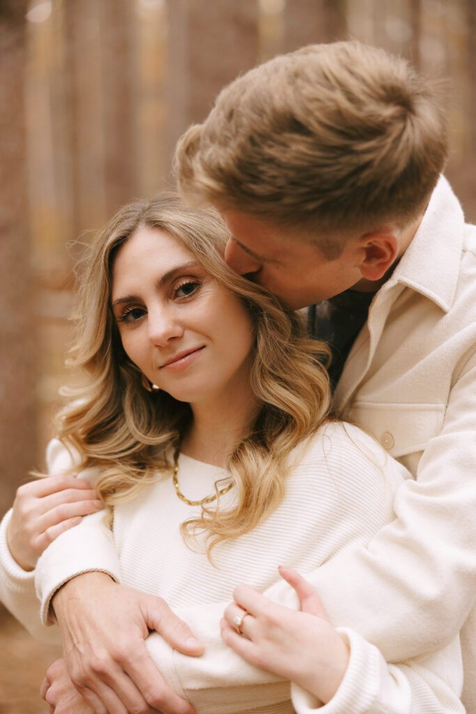Sophia and Brad  embrace in an oak grove for their oak openings engagement photos