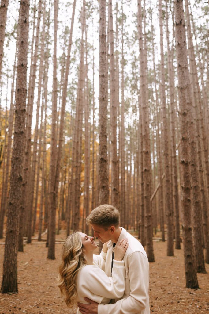 Sophia and Brad  embrace in an oak grove for their oak openings engagement photos