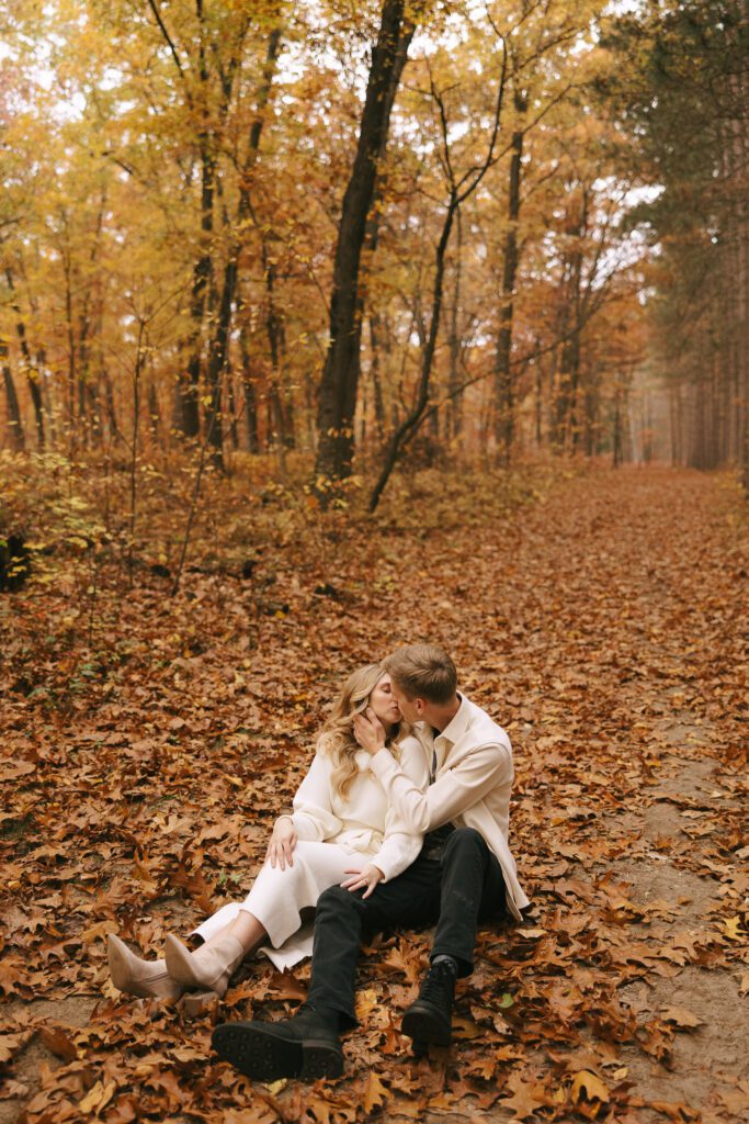 Sophia and Brad sit in the leaves