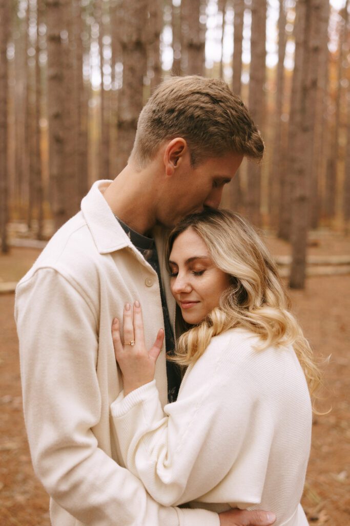 Sophia and Brad embrace in an oak grove for their oak openings engagement photos