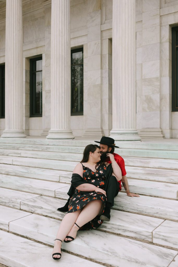 Adam and Bethany sit together on the steps of the Monroe street entrance of the Museum