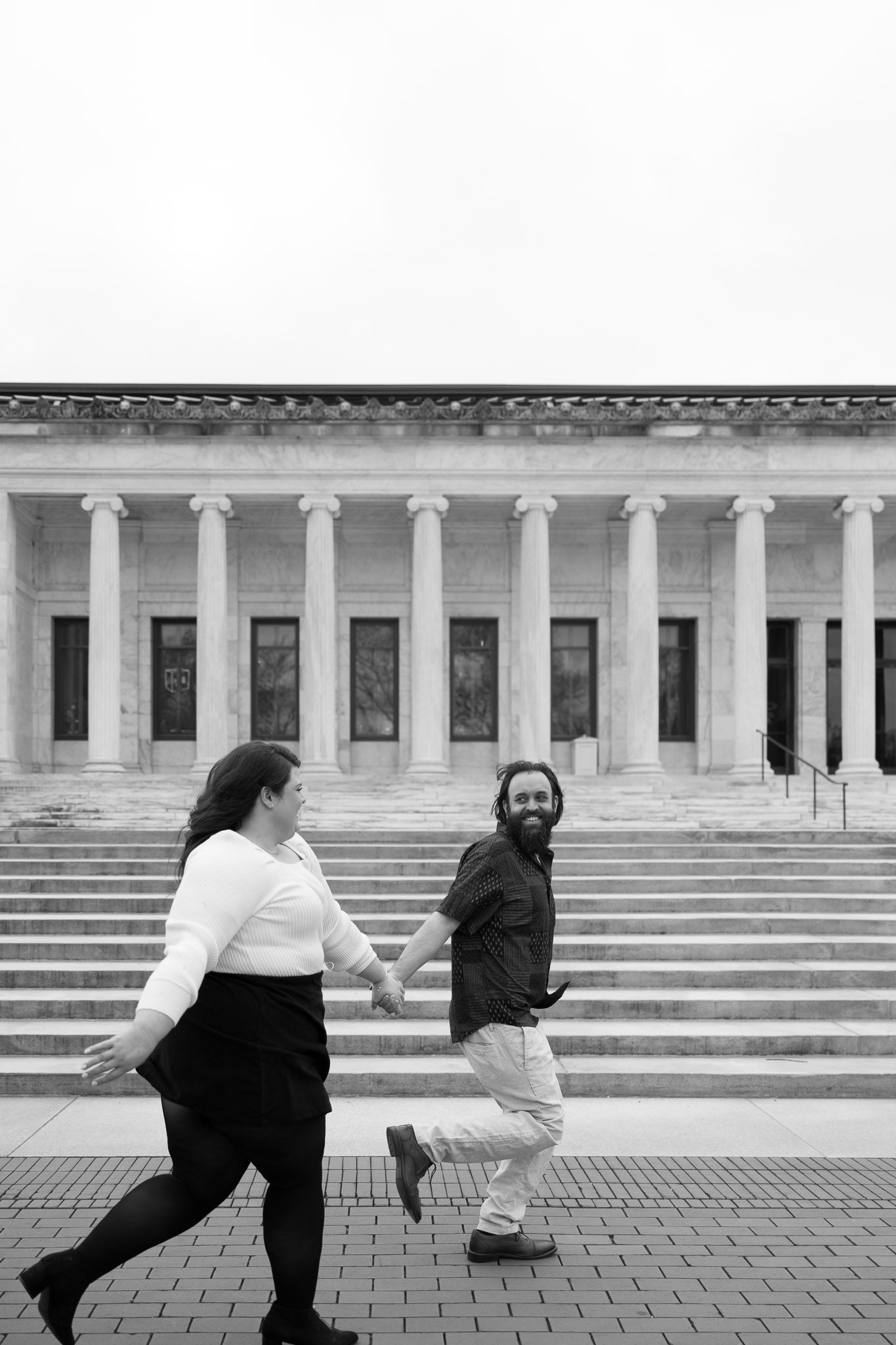 Bethany and Adam run in front of the museum