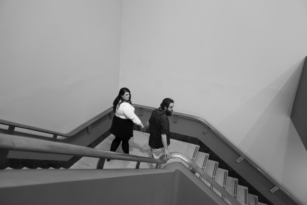 Adam and Bethany walk down the steps at the art museum