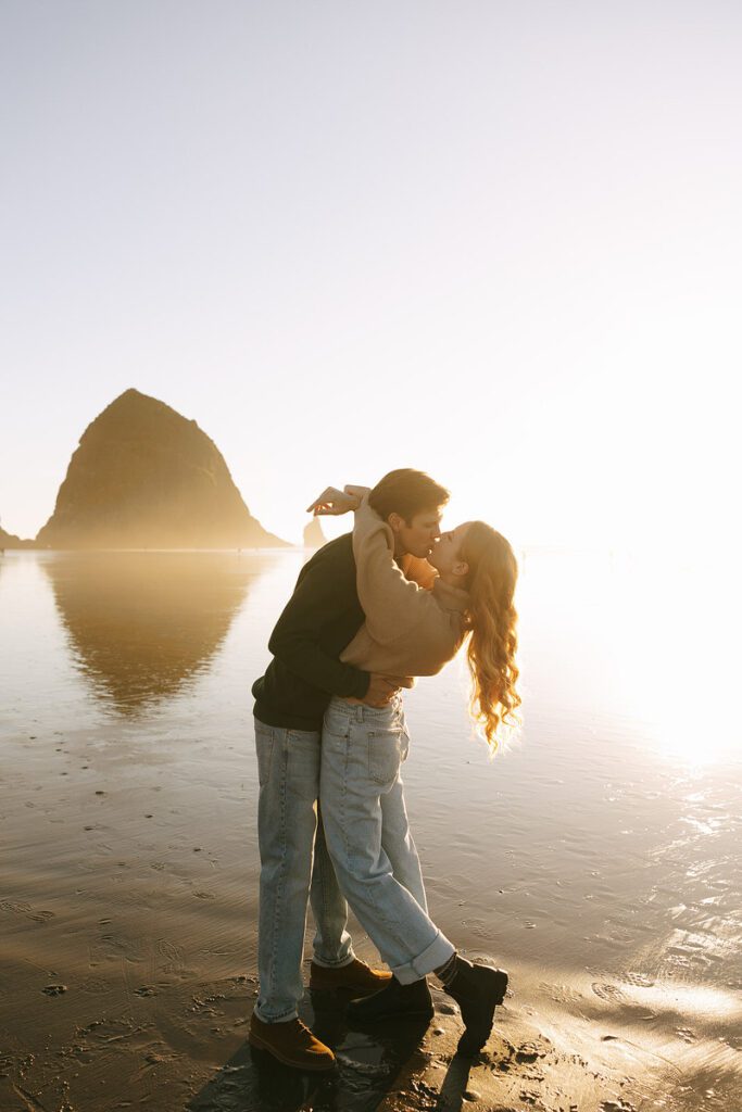 J&L embrace and kiss on the beach for their engagement photos