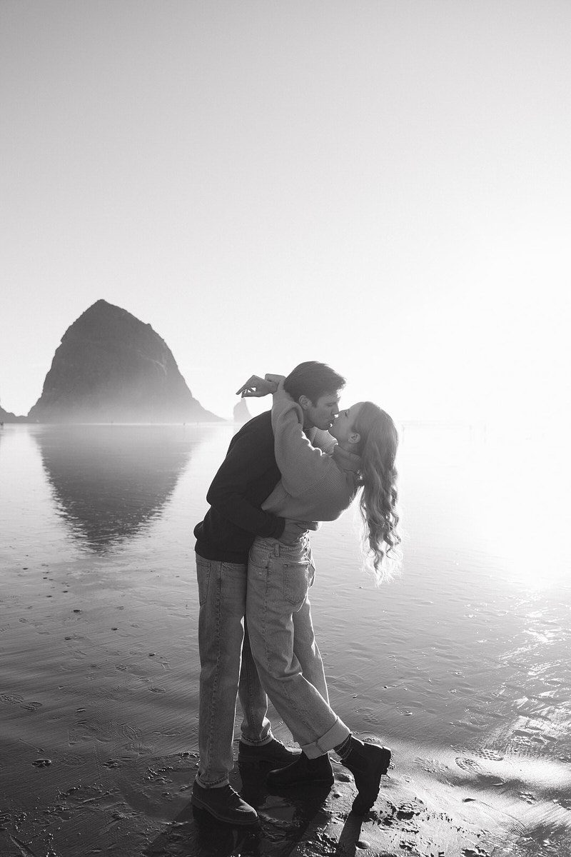 J&L embrace on the beach for their engagement photos