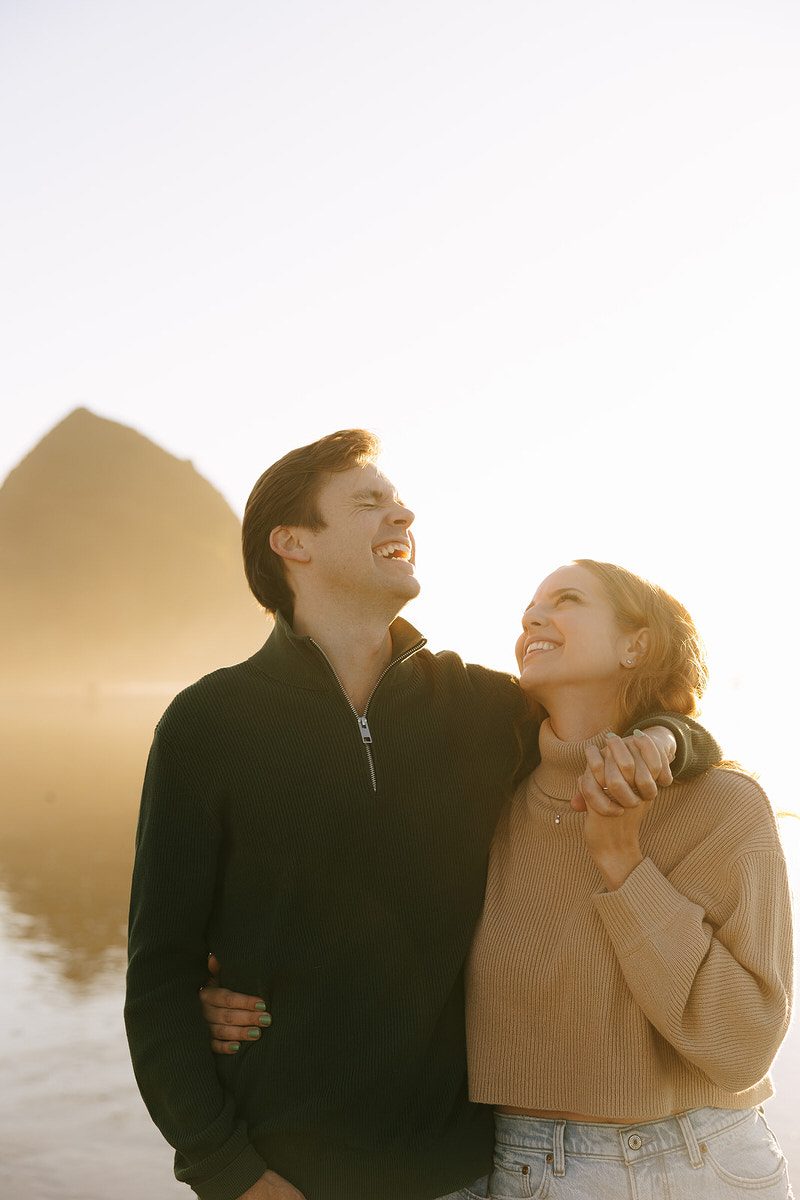 J&L laugh during their Cannon Beach engagement