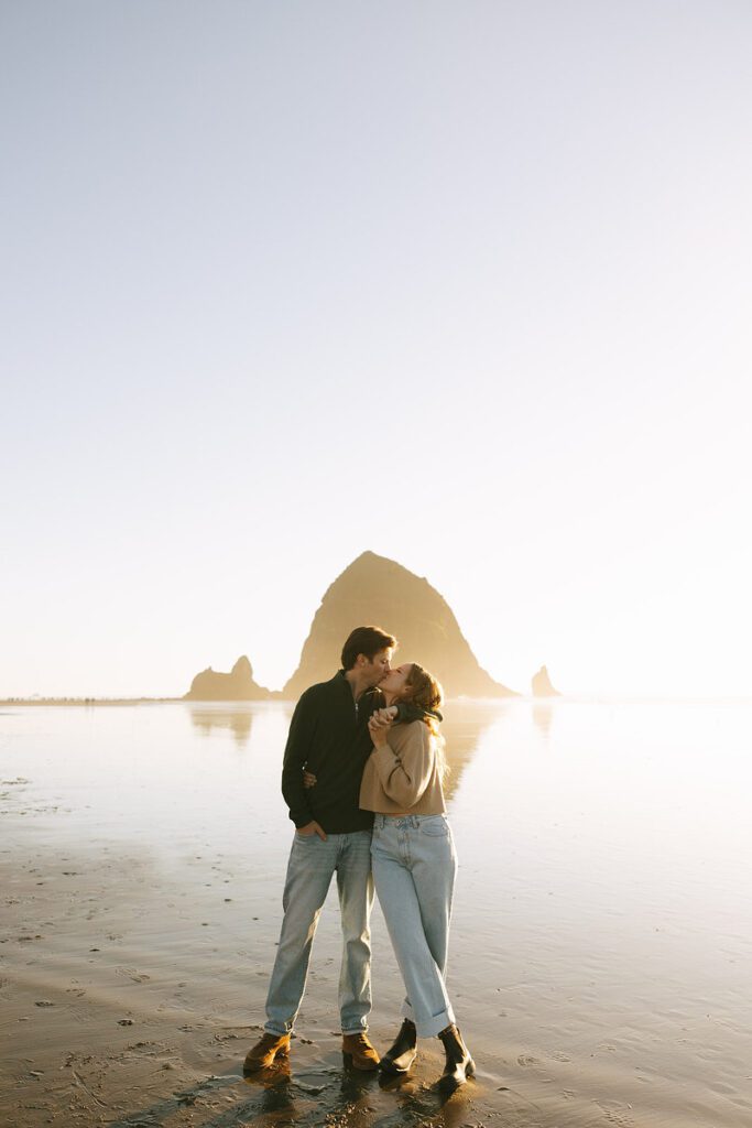 J&L embrace and kiss on the beach for their engagement photos