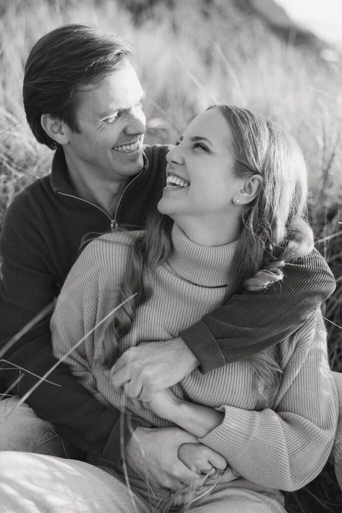 J&L hug while sitting on a dune