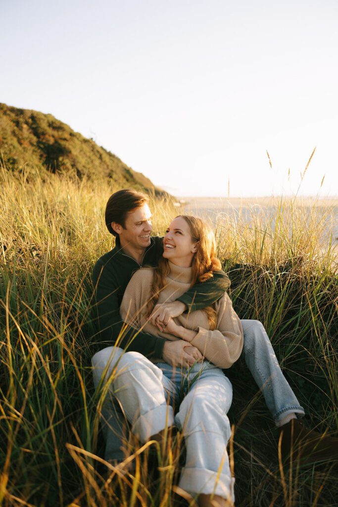 J&L hug while sitting on a dune