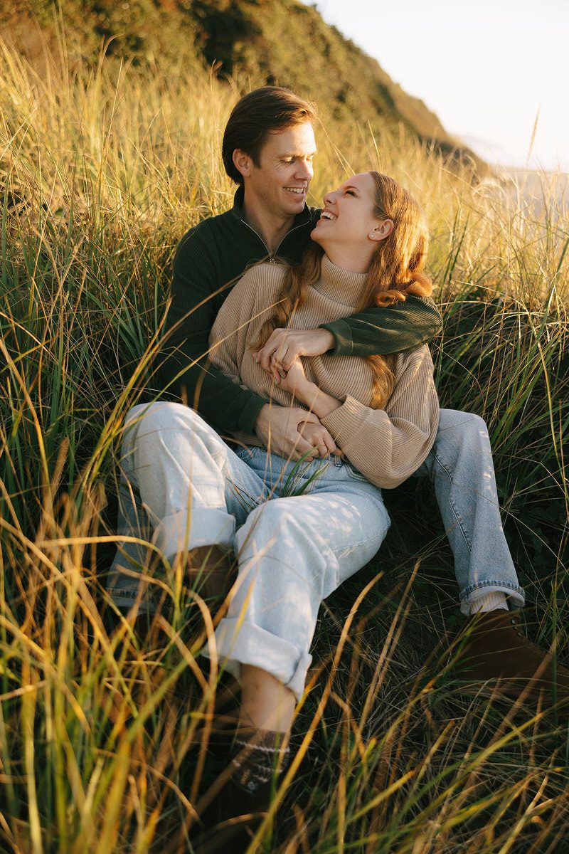 J&L hug while sitting on a dune