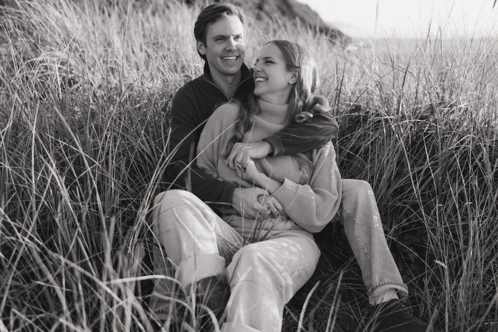 J&L hug while sitting on a dune