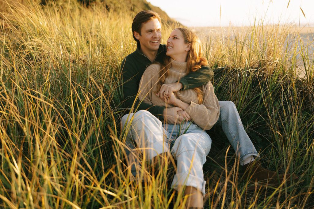 J&L hug while sitting on a dune