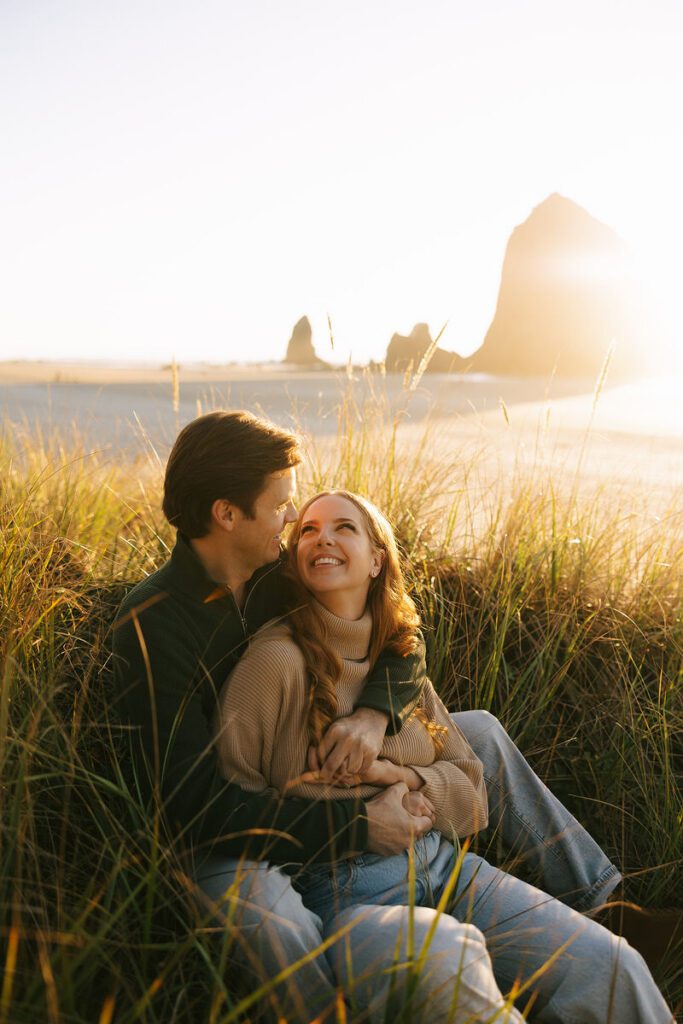 J&L hug while sitting on a dune