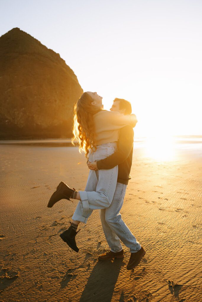 Jason lifts and spins Leah on the beach