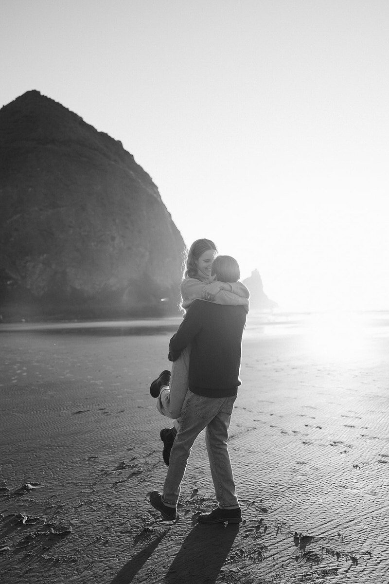 Jason lifts and spins Leah on the beach