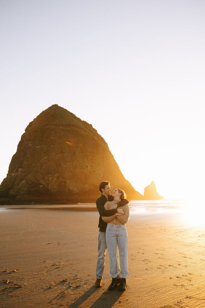 Jason and Leah embrace on the beach