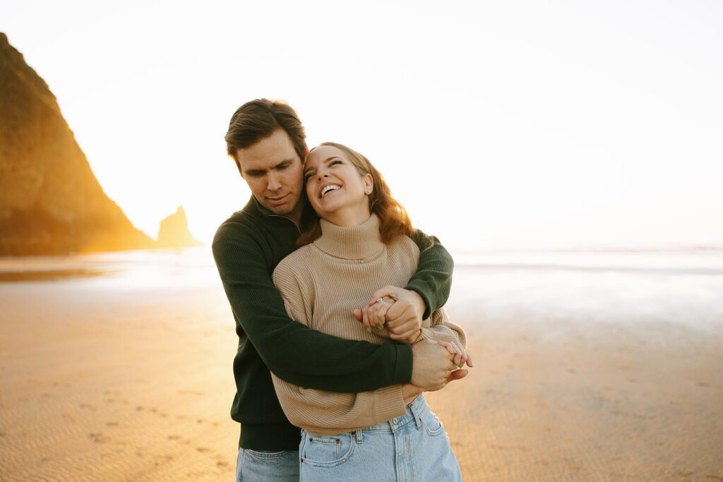 Jason and Leah embrace on the beach