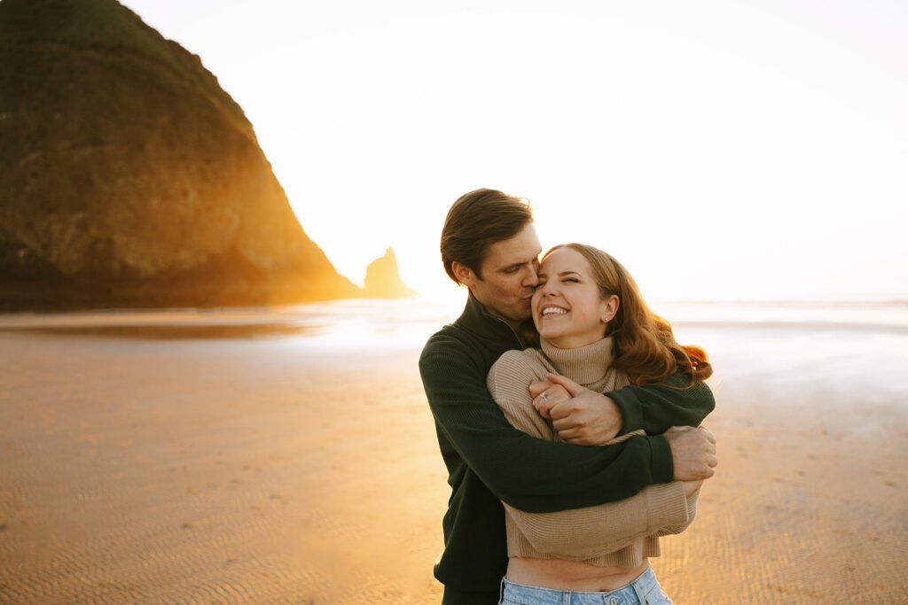 Jason and Leah embrace on the beach