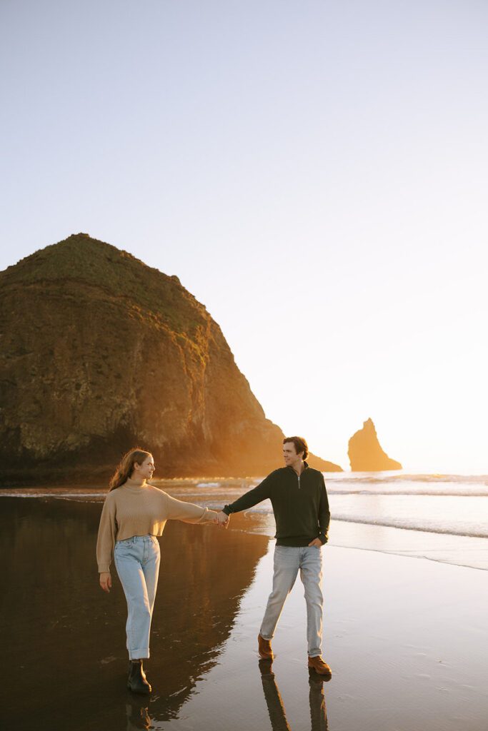 Jason and Leah walk down the shore for their Cannon Beach Engagement