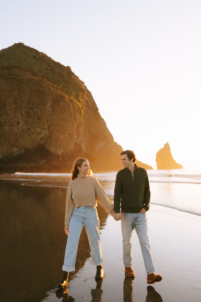 Jason and Leah walk down the shore for their Cannon Beach Engagement