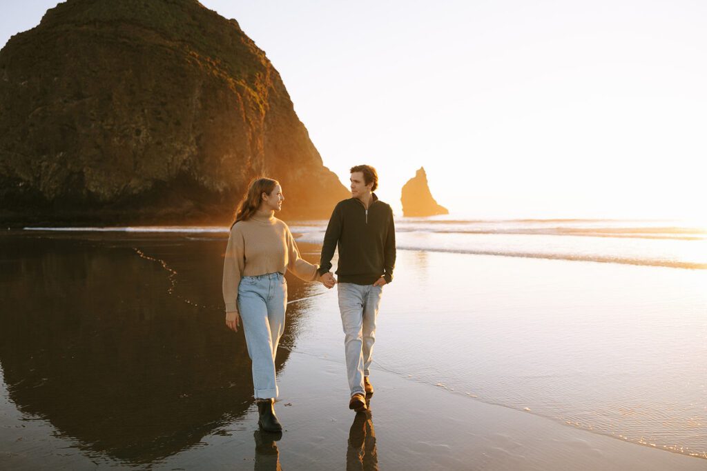 Jason and Leah walk down the shore