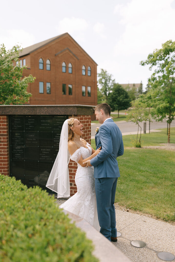 The couple embraces during their first look