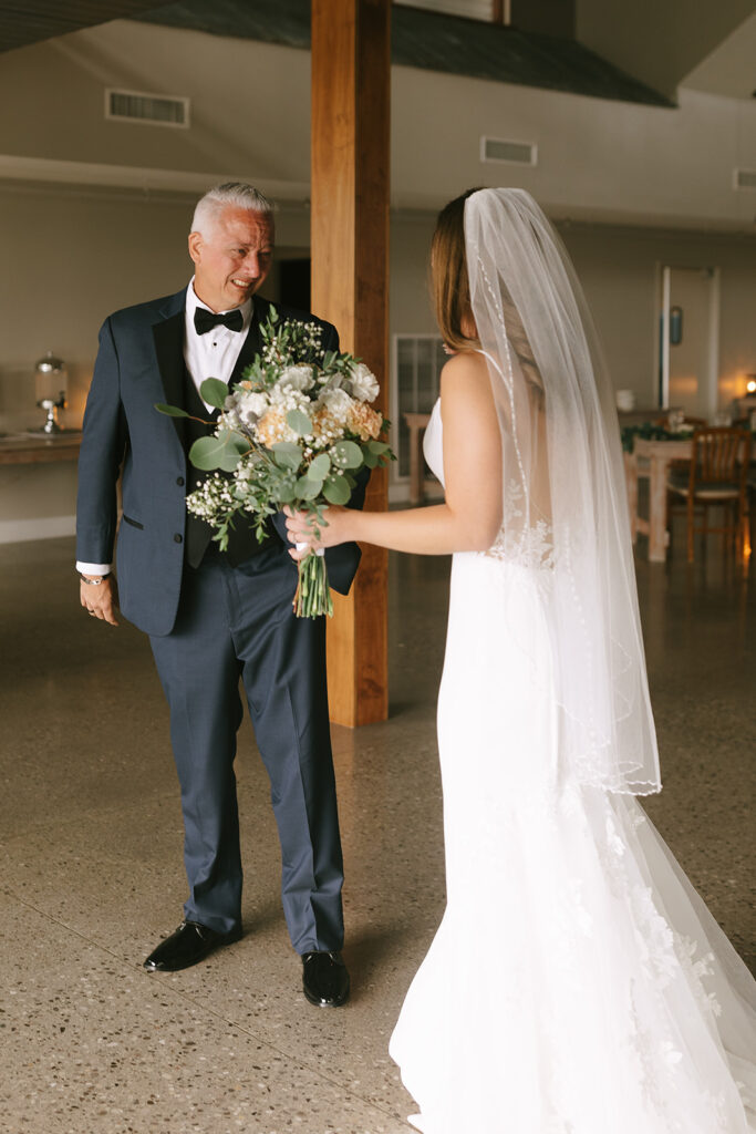 Meg goes to hug her dad during their first look