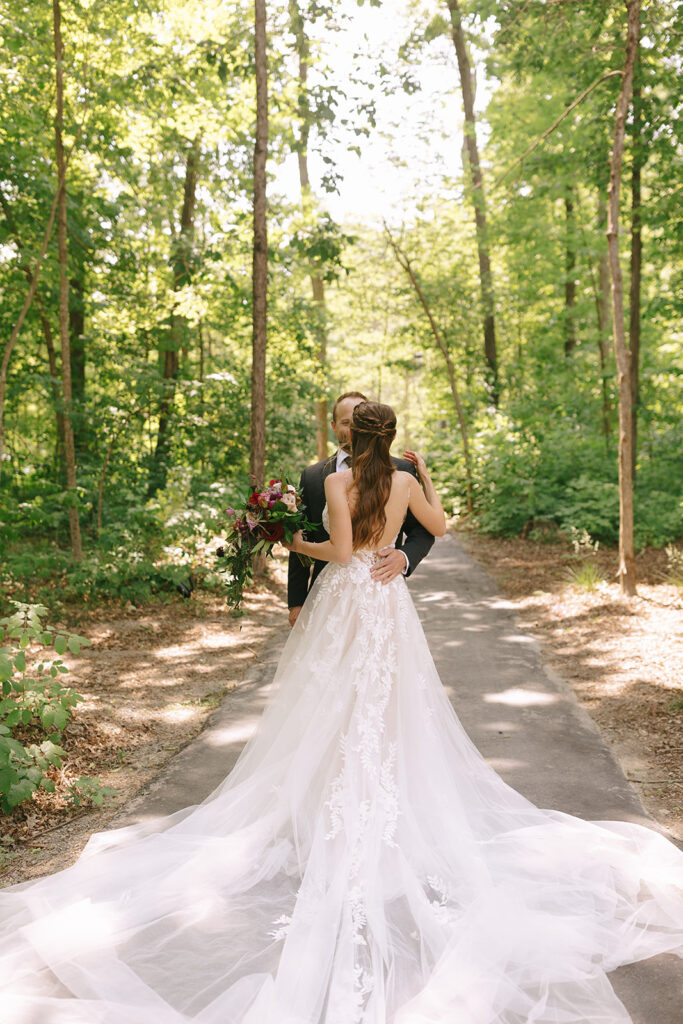 The couple embraces during their first look