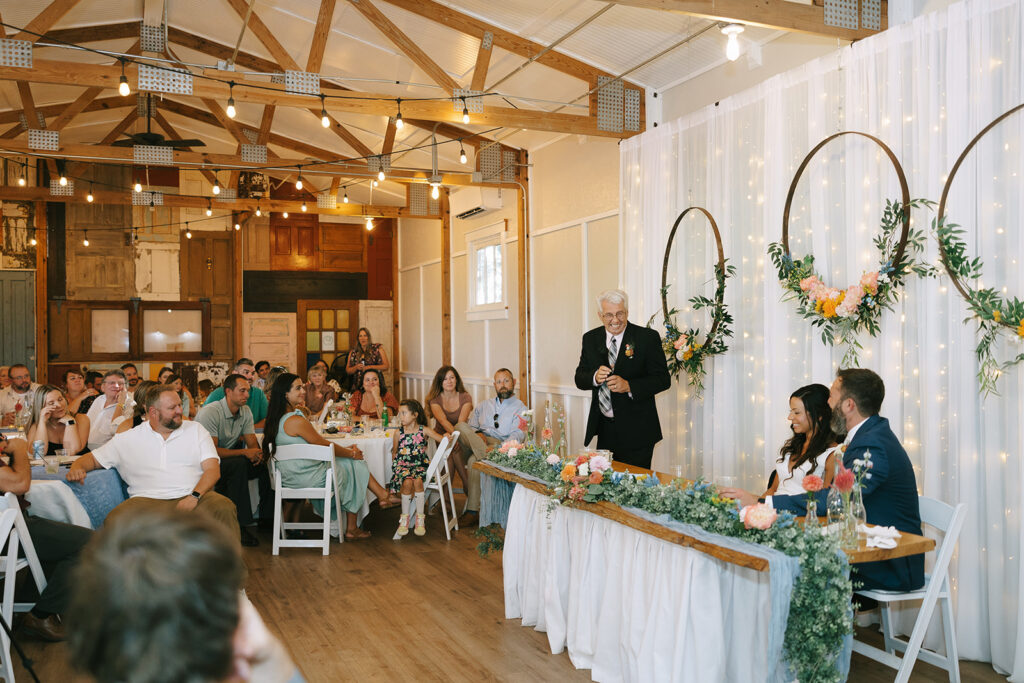 Tony's dad give a wedding toast during their wedding reception