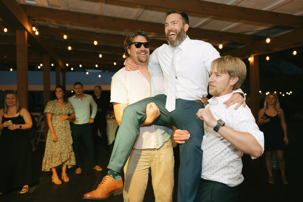 Tony's friends lift him during their wedding reception at Bloom and Bower