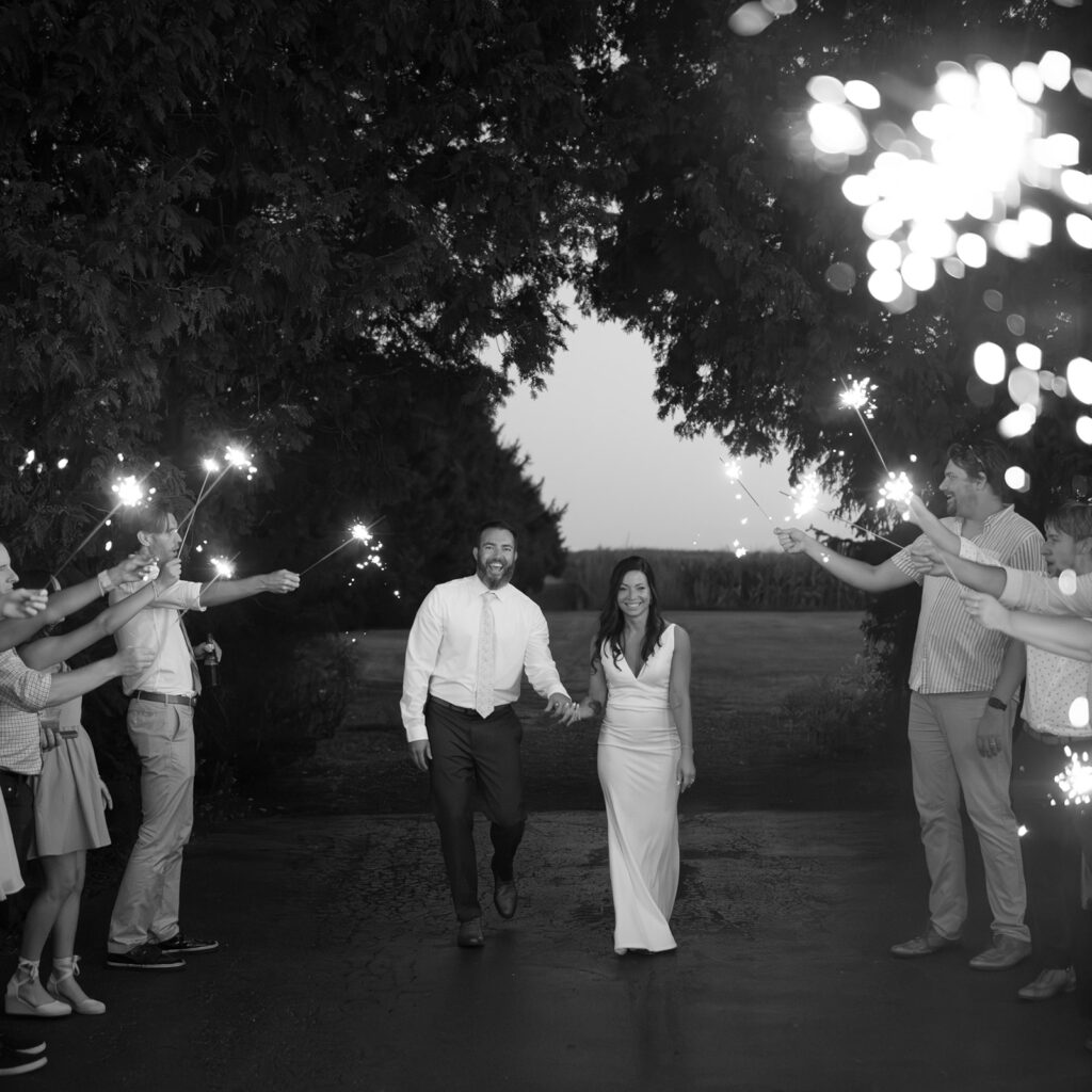 Karis and Tony walk down their sparkler exit at their wedding reception