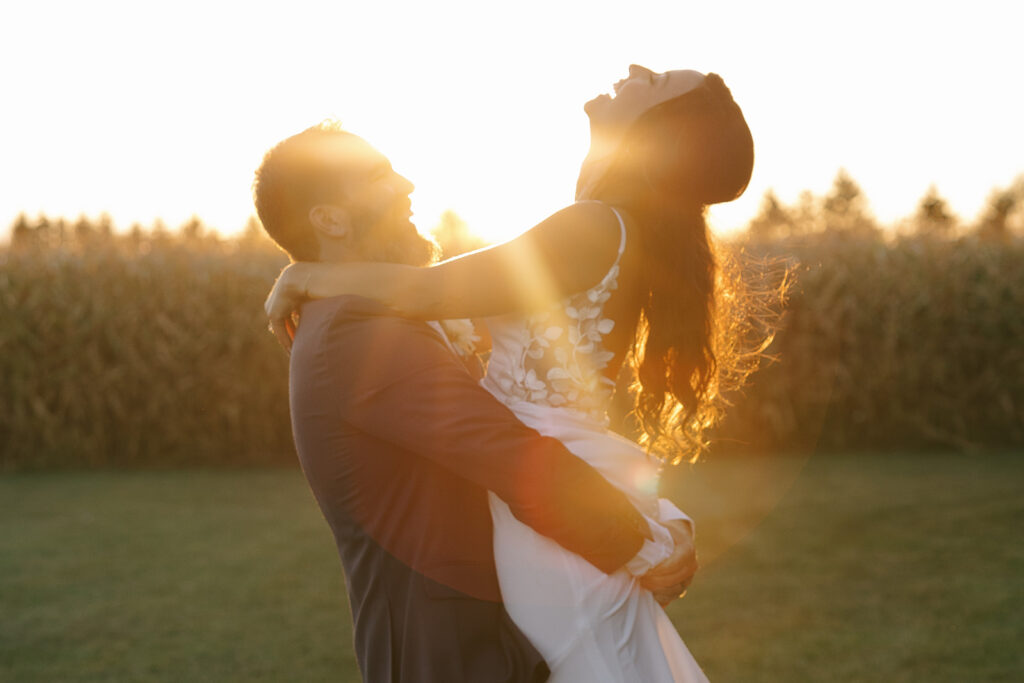 Tony lifts Karis as she laughs during sunset portraits