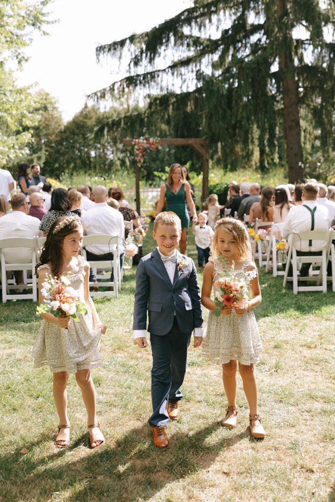 The ringbearer and flower girls walk back down the aisle