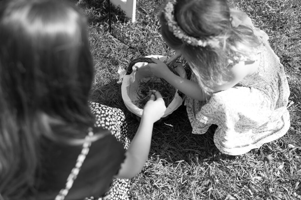 The flower girls pick up their wildflower petals following Karis and Tony's wedding at Bloom and bower