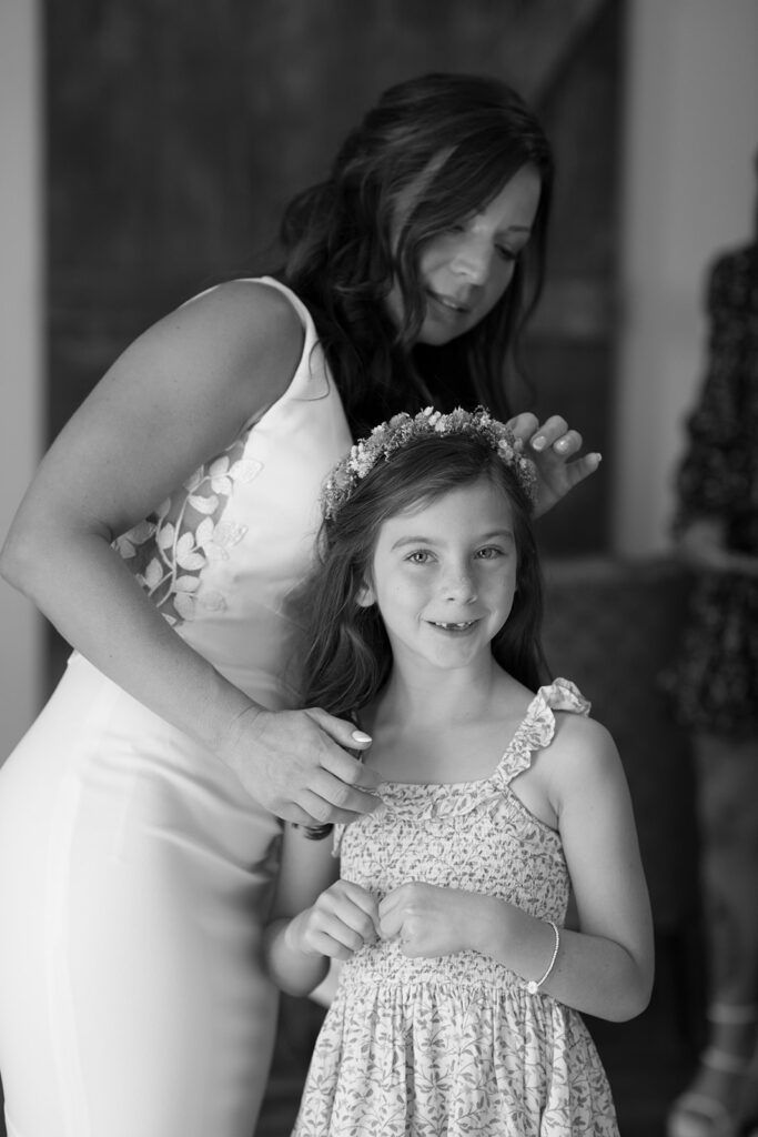 Karis helps her daughter with her wildflower flower crown