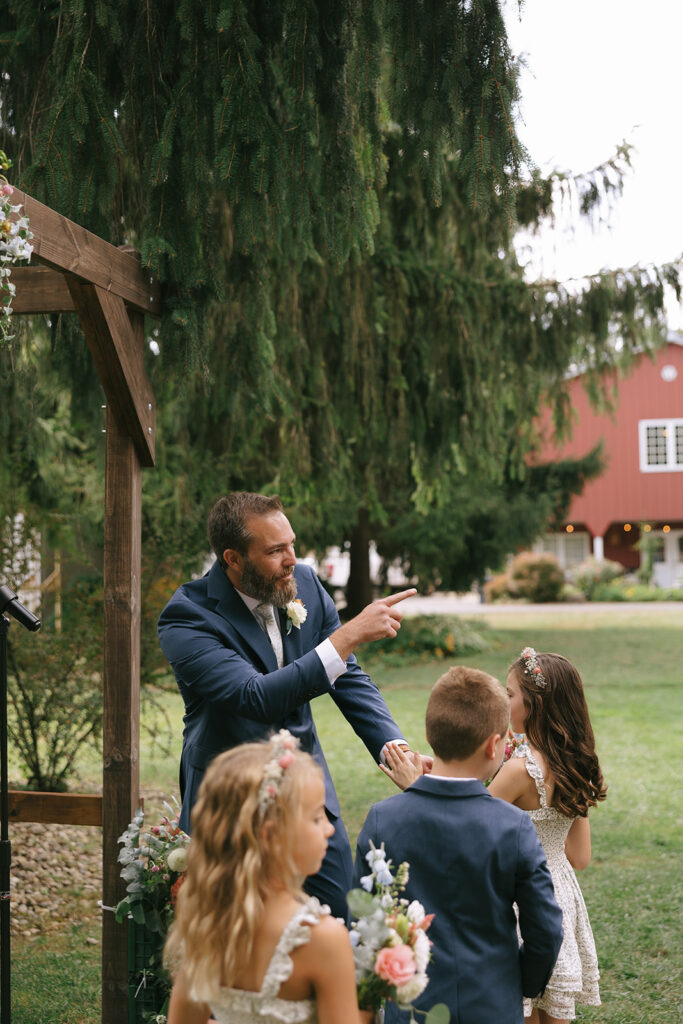 Tony points as Karis is walking down the aisle toward him at Bloom and Bower