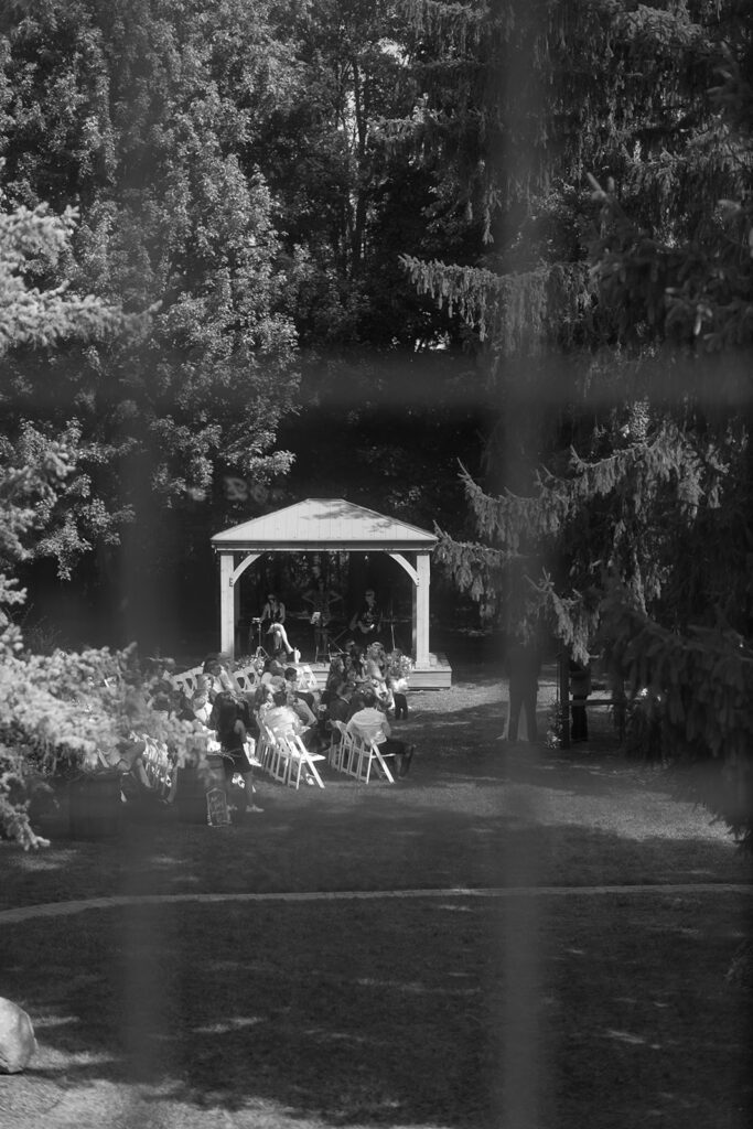 A window view of the ceremony during Tony and Karis's wildflower wedding at bloom and bower