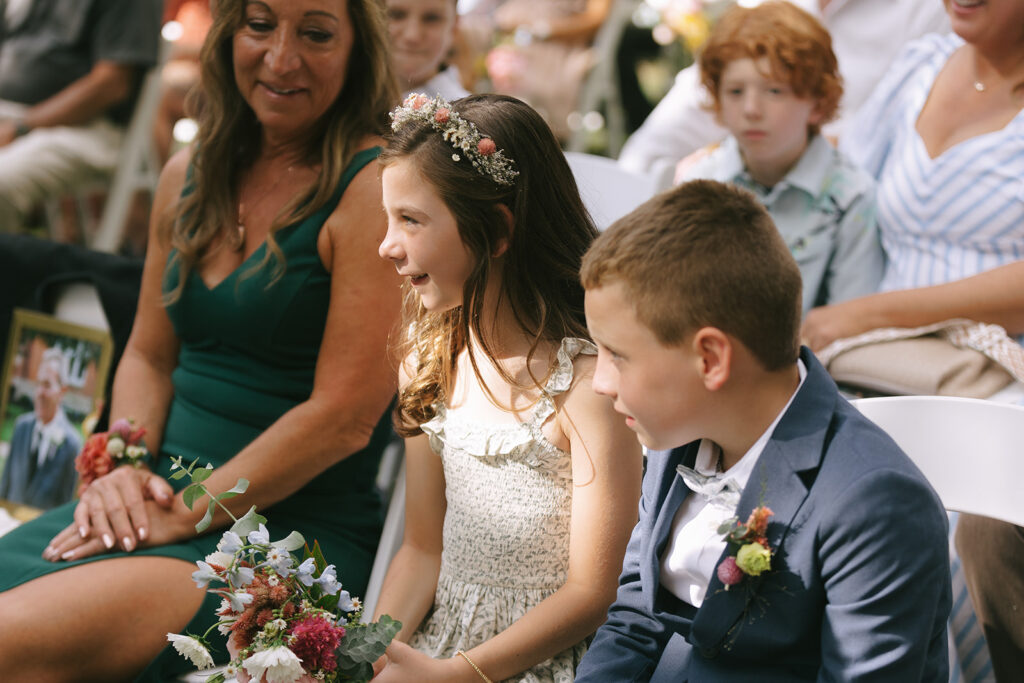 Karis's daughter looks at Tony during vows at her moms bloom and bower wedding