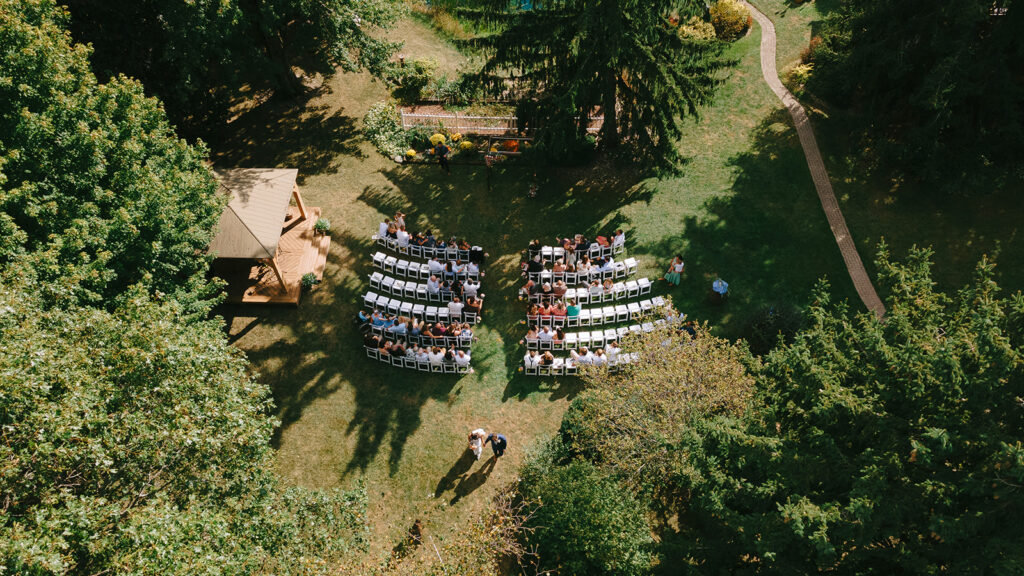 an aerial view of Karis and Tony walking back down the aisle together during their wedding at Bloom and Bower